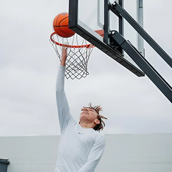 A young athlete finishing at the rim during tournament play